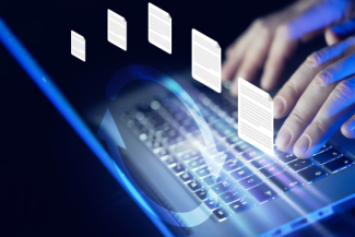 Decorative. Closeup of hands typing on a laptop, using secure file transfer software