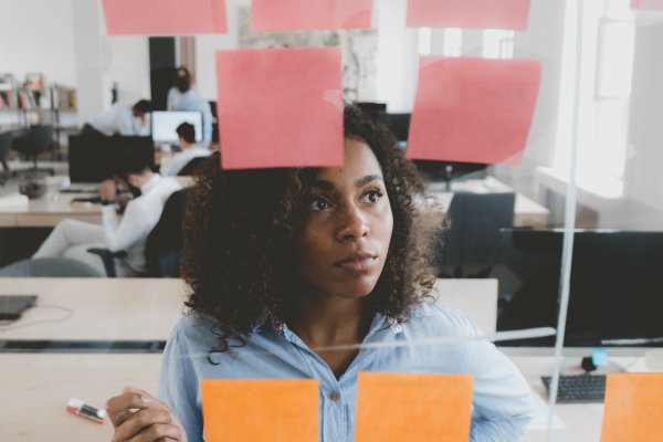 Woman looking quizzically at sticky notes